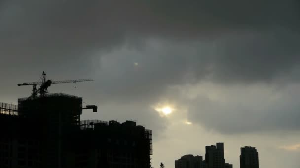 Moln täcker solen sky, bygga high-rise, hus siluett. — Stockvideo