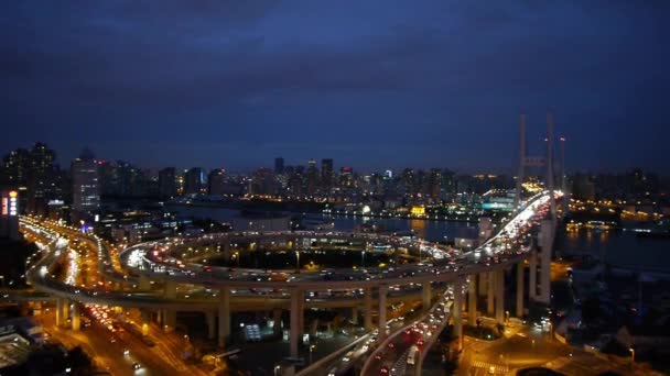 Panoramic of urban busy overpass traffic interstate at night,shipping on river. — Stock Video