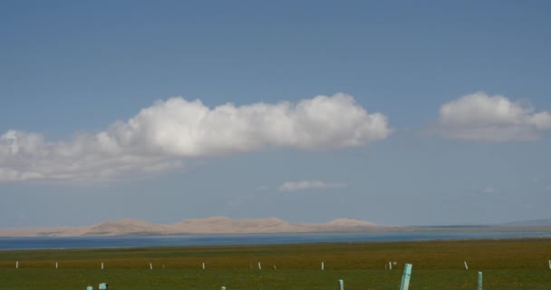 4k far away wide prairie & desert,white puffy cloud mass rolling over blue lake — Stock Video