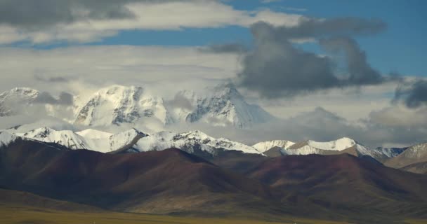 4k enormes nubes rodando sobre el Tíbet montañas cubiertas de nieve . — Vídeo de stock