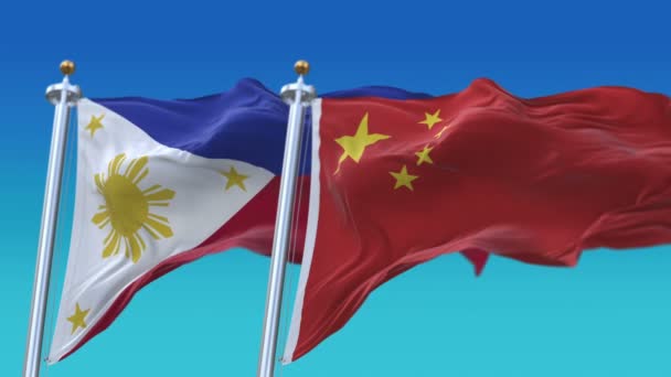 4k Dikişsiz Filipinler ve Çin Bayrakları mavi gökyüzü arka plan ile, Phi Ph Chn Cn. — Stok video