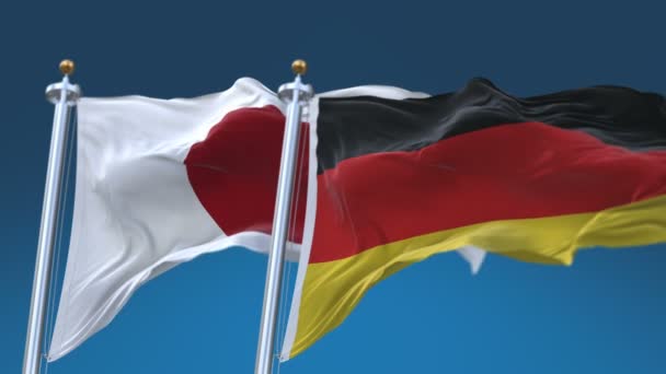 4k naadloze Duitsland en Japan vlaggen met blauwe hemel achtergrond, Ger de JPN JP. — Stockvideo