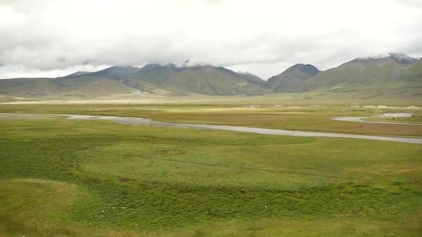 4 k 云大众滚过西藏山，河流流经大草原. — 图库视频影像