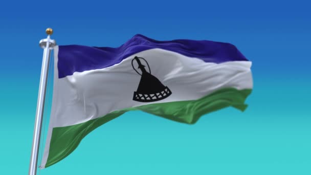 4k Lesotho Nationale vlag rimpels zwaaien wind hemel naadloze lus achtergrond. — Stockvideo