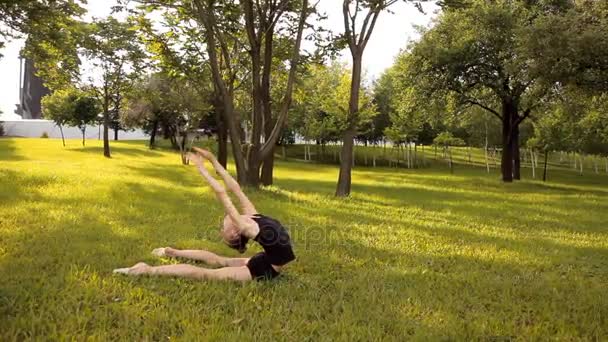 Menina realiza exercícios de ginástica na natureza — Vídeo de Stock