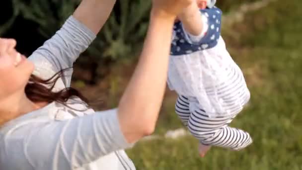 Mladí rodiče hrát se svým dítětem na pikniku v parku rekreace — Stock video