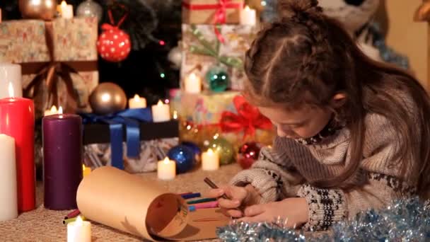 Une petite fille dessine ses vœux dans une lettre de Noël au Père Noël — Video