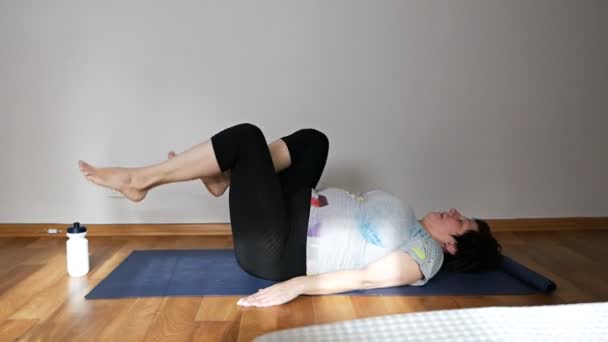 Mulher idosa saudável fazendo pilates ou ioga, exercícios de alongamento — Vídeo de Stock