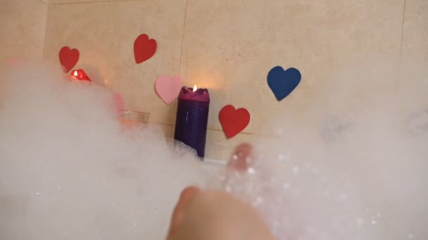 Χαλαρώστε μπάνιο, που βρίσκεται στο αφρόλουτρο, ρομαντική βραδιά για την Ημέρα του Αγίου Βαλεντίνου. Αισθητική φροντίδα, ψυχαγωγία και υγειονομική περίθαλψη έννοια — Αρχείο Βίντεο