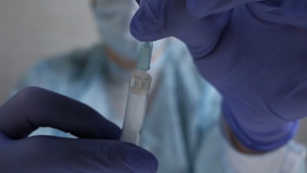 Syringe with blood. Close-up syringe with medicine ready for injection. A medical syringe filled with red liquid. Chinese virus — Stock Video