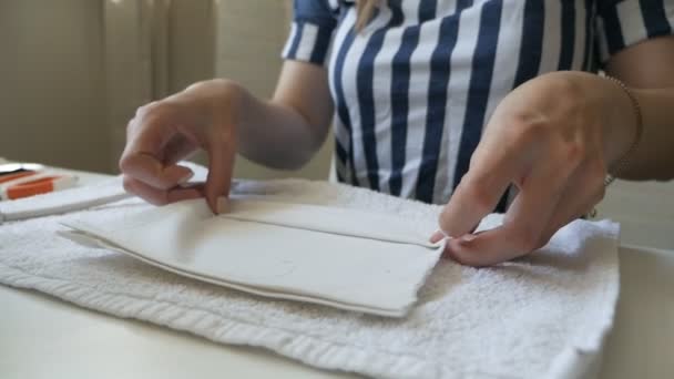 Reusable fabric face mask steamed and ironed for reuse. Hot steam treatment, disinfection of medical masks. The concept of deficiency of medical masks during the coronavirus pandemic — Stock Video