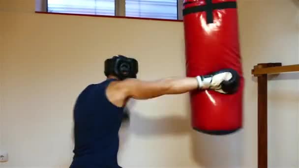 Strong Young Boxer Hitting Boxing Bag — Stock Video