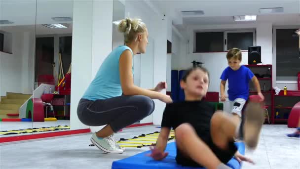 Children Practicing Somersault Supervision Trainer — Stock Video