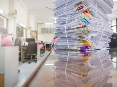 İş kadını arka plan ile ofis masasında tamamlanmamış belgeler yığını