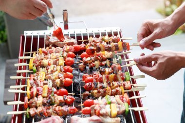 Friends having party and cooking barbecue in gardern.