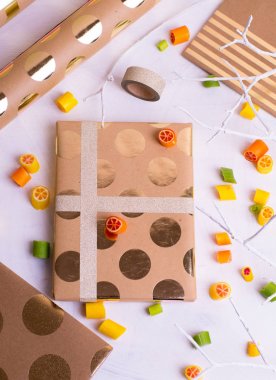 Arkadaşları ve yakınları için hediyeler yapma. Kolaj kağıt, tatlılar, hediye çanta ve kurdeleler sarma