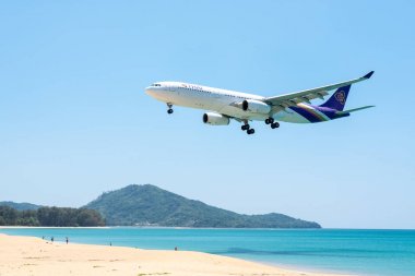 PHUKET, THAILAND - MARCH 11: Landing airplane at Phuket internat clipart