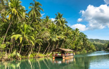 traditional raft boat with tourists on a jungle green river Lobo clipart