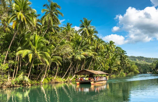 Traditionelles Floßboot mit Touristen auf einem Dschungel grünen Fluss lobo — Stockfoto