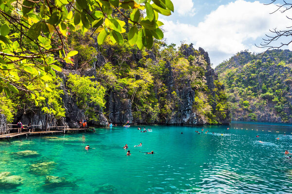 People tourists swimming at Kayangan Lake in Coron Island, Palawan, The Philippines.