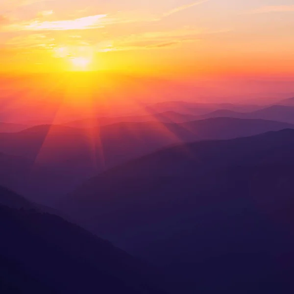 Silhouettes of the mountain hills at sunset — Stock Photo, Image