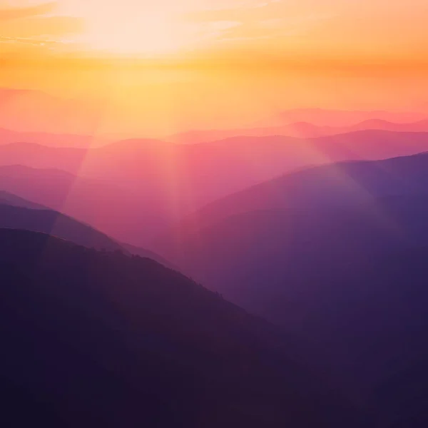 Silhouettes of the mountain hills at sunset — Stock Photo, Image