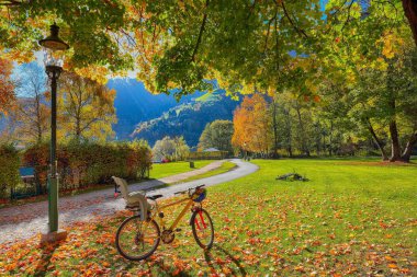 Spectacular autumn view of lake and trees in city park of Sell A clipart