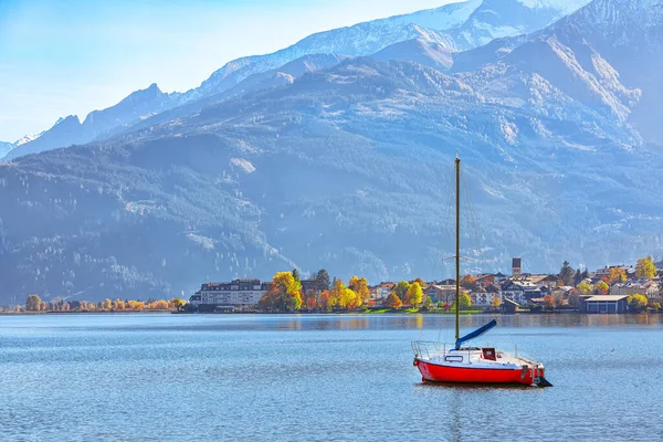 Spectacular autumn view of lake and yachts in city Sell Am See.
