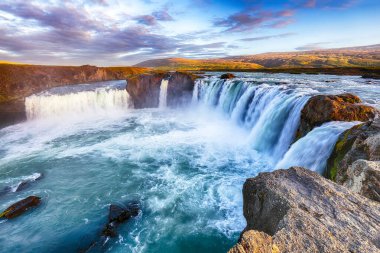 Güçlü Godafoss şelalesinin nefes kesici gün batımı manzarası