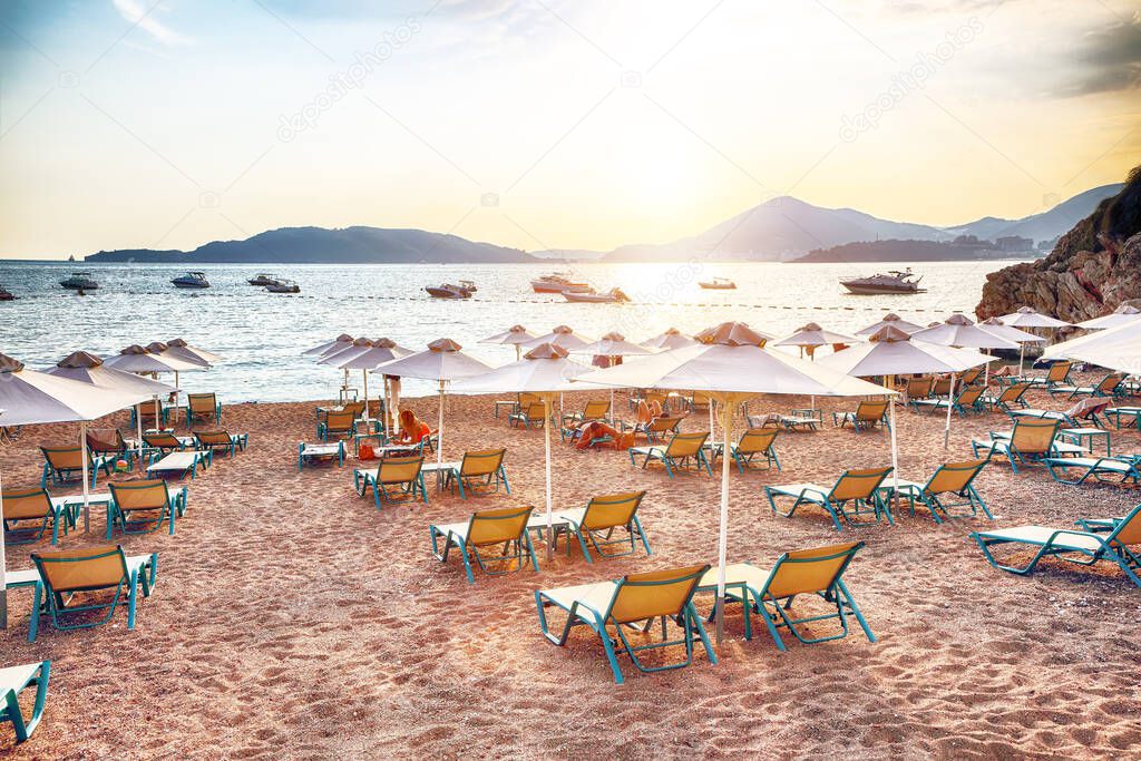 Picturesque summer view of Adriatic sea coast in Budva Riviera near Przno village. Cozy beach with umbrellas. Location: Przno village, Montenegro, Balkans, Europe