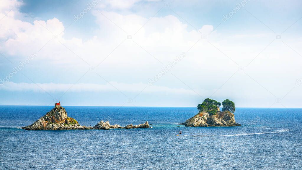 Beautiful view of Adriatic sea with small islet Sveta Nedelja. Location: Petrovac town, Montenegro, Balkans, Europe