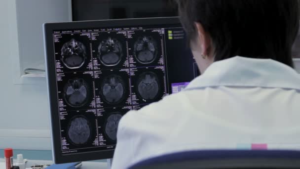Доктор, работающий с рентгеновским мозгом на компьютере — стоковое видео