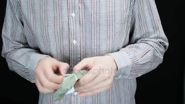 A man checks a pile of money — Stock Video