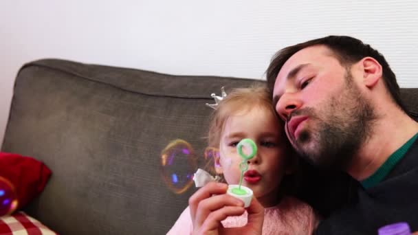 Nöjd pappa och dotter blåser såpbubblor. — Stockvideo