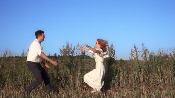 Young couple romantic story, a girl jumps into the hands of a guy — Stock Video