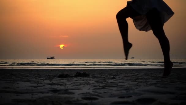 Girl with the barefoot in the dress jumping at the beach legs close up — Stock Video