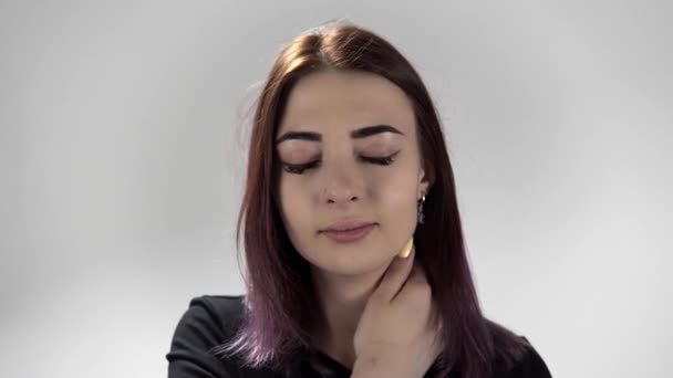 Portrait of young woman holding her neck being upset and blinking almost crying — Stock Video