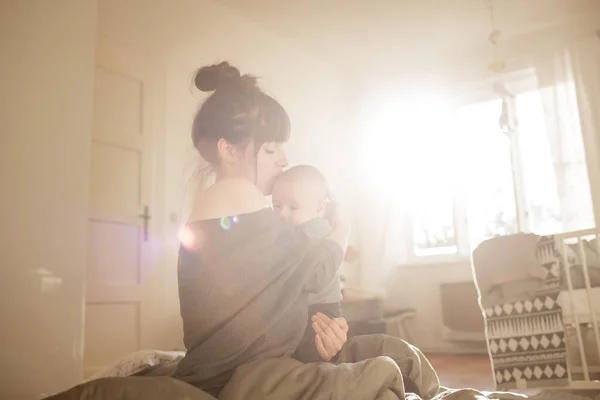 Young mother holding her newborn baby