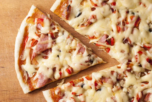 Pizza on a wooden background — Stock Photo, Image