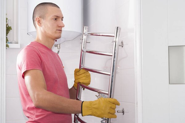 man installs towel dryer