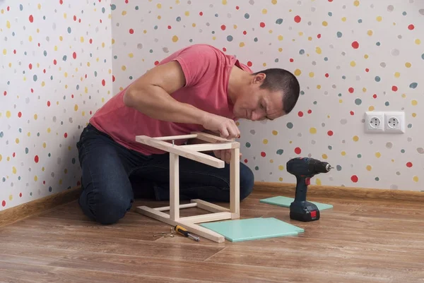 Père assemble une chaise pour enfants — Photo