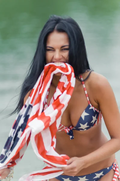 Girl on the beach with american flag — Stock Photo, Image