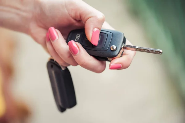 Car key in woman\'s hand. Seller and transport insurance.