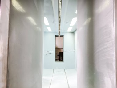 Toz kaplama hattı. Metal paneller, üstteki taşıma hattında askıya alındı. Elektrostatik alanda boyama ürünleri.