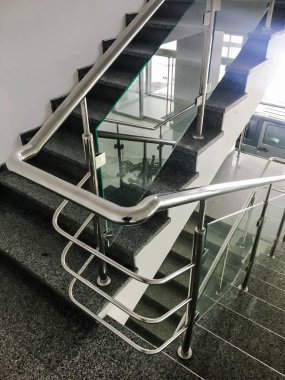 Merdivenlerin yanındaki paslanmaz çelik parmaklık.
