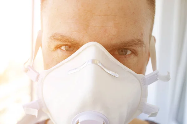A man in a protective mask to prevent respiratory diseases in quarantine