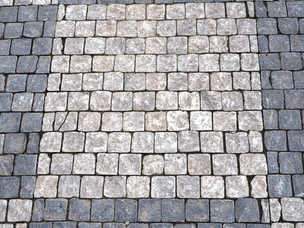 Paving grey stone texture, stone footpath background.