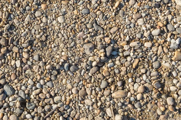 Pebble beach texture on the river bank — Stock Photo, Image