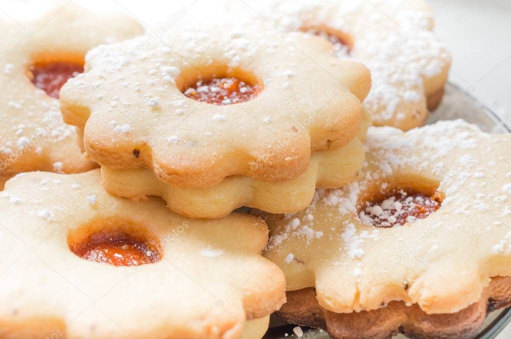 Homemade apricot jam Linzer with icing sugar close up