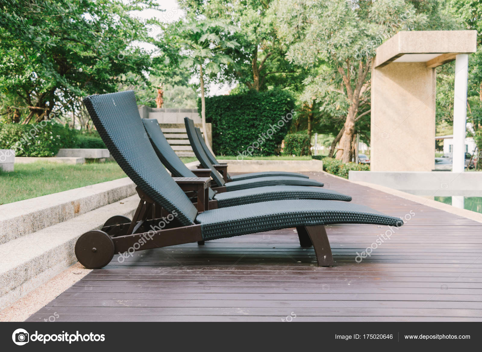 Black Swimming Chair Bench On Wooden Floor Beside Swimming Pool